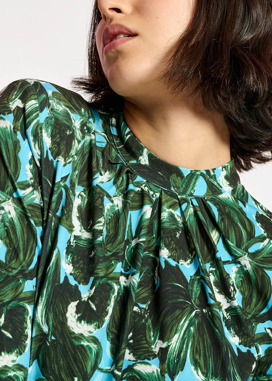 Blue and dark green leaf-print mock neck top